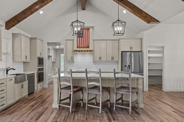 2017 Antler Loop, Poolville, TX 76487 - kitchen with an inviting chandelier, beam ceiling, a sink, stainless steel appliances, and wood finished floors