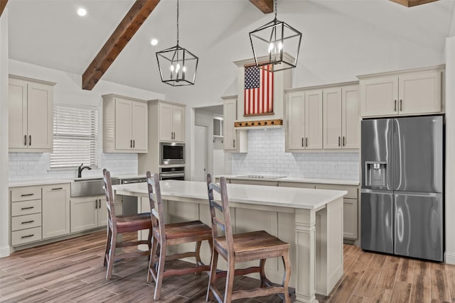 2017 Antler Loop, Poolville, TX 76487 - kitchen featuring light countertops, stainless steel appliances, beamed ceiling, and light wood finished floors