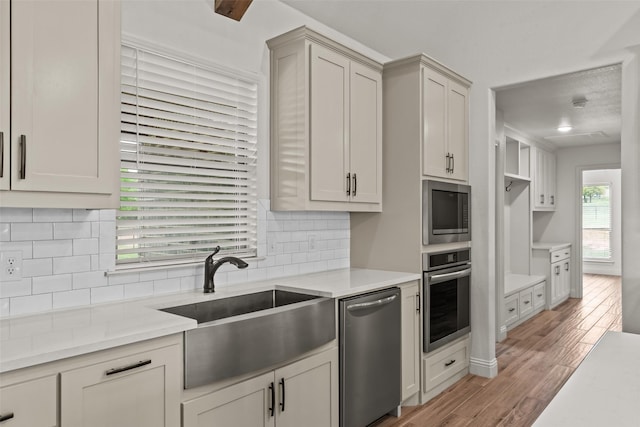 2017 Antler Loop, Poolville, TX 76487 - kitchen with light countertops, appliances with stainless steel finishes, decorative backsplash, and a sink