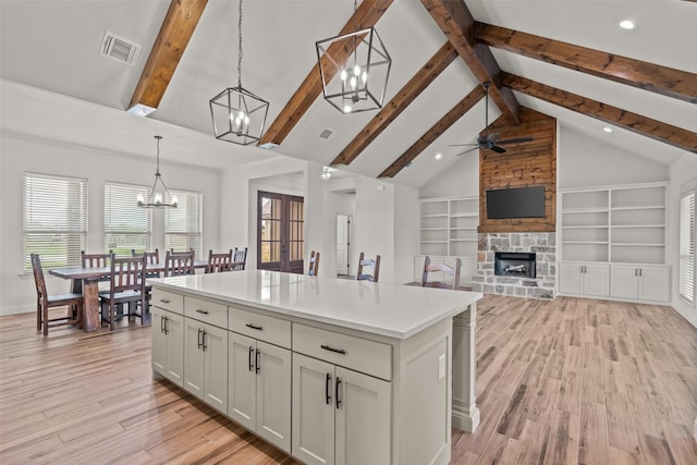 2017 Antler Loop, Poolville, TX 76487 - kitchen featuring visible vents, pendant lighting, light wood-style floors, light countertops, and ceiling fan with notable chandelier