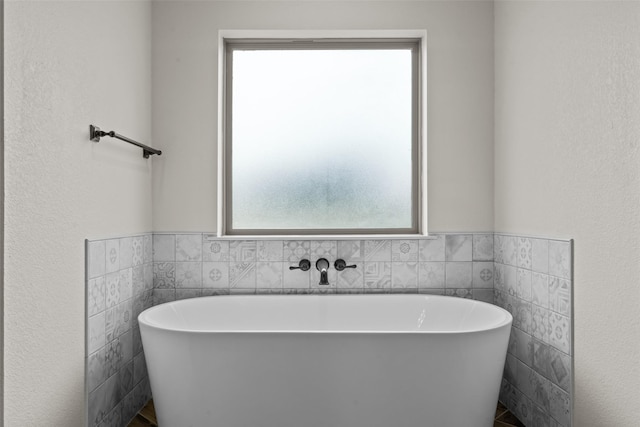 2017 Antler Loop, Poolville, TX 76487 - bathroom with wainscoting, a freestanding bath, and tile walls