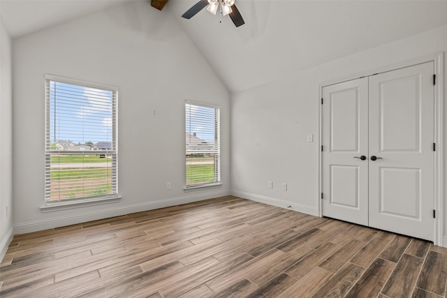 2017 Antler Loop, Poolville, TX 76487 - unfurnished bedroom featuring a ceiling fan, beam ceiling, wood finished floors, high vaulted ceiling, and a closet