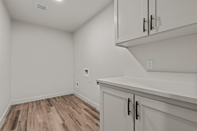 2017 Antler Loop, Poolville, TX 76487 - clothes washing area featuring cabinet space, light wood-style floors, baseboards, and hookup for a washing machine