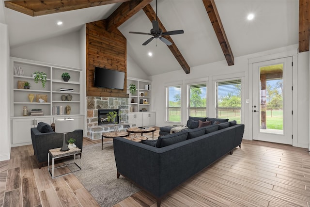 2017 Antler Loop, Poolville, TX 76487 - living area with ceiling fan, a stone fireplace, beam ceiling, light wood finished floors, and recessed lighting