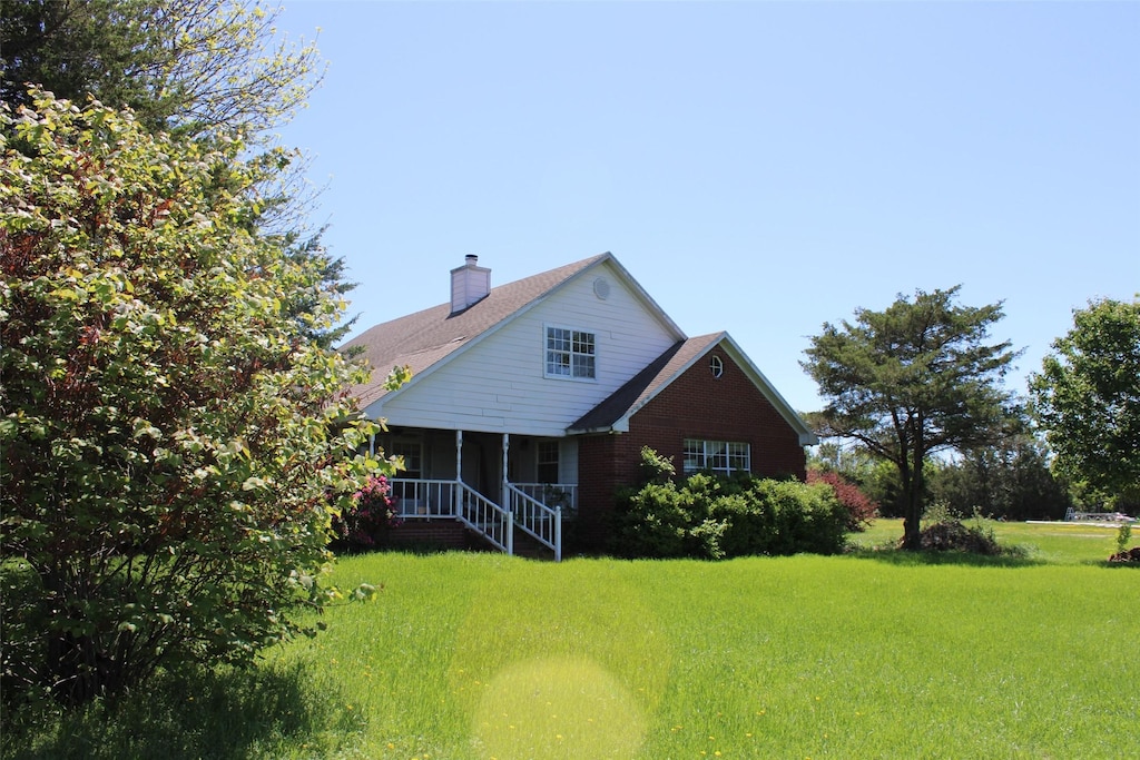 938 County Road 4900, Trenton, TX 75490 - back of house featuring a lawn and a chimney
