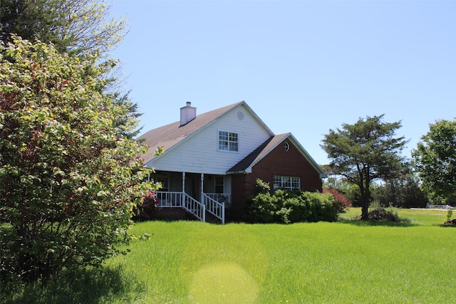 938 County Road 4900, Trenton, TX 75490 - back of house featuring a lawn and a chimney