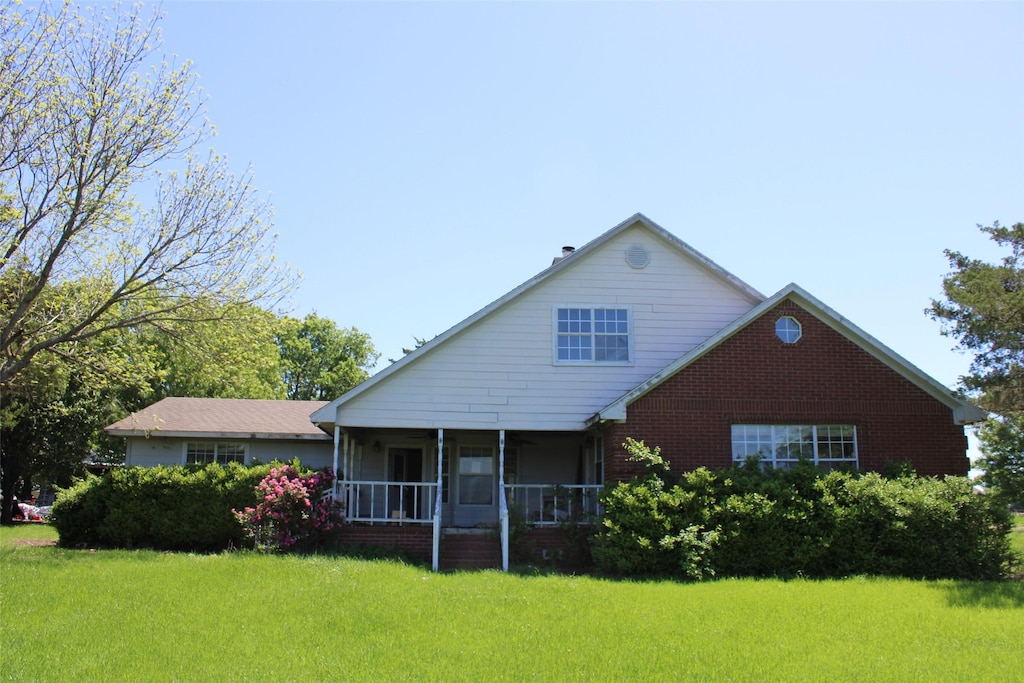 938 County Road 4900, Trenton, TX 75490 - rear view of property with a lawn and brick siding
