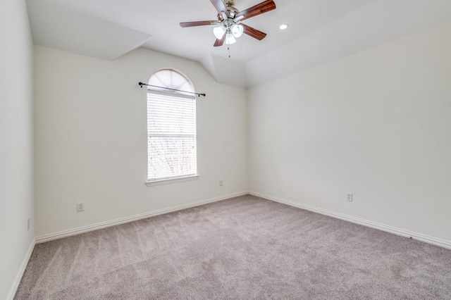empty room featuring vaulted ceiling, recessed lighting, carpet, baseboards, and ceiling fan