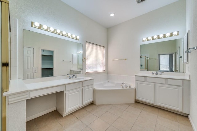 bathroom featuring a bath, a sink, a stall shower, and tile patterned flooring