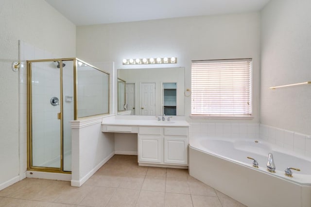 bathroom featuring a stall shower, tile patterned floors, vanity, a bath, and baseboards