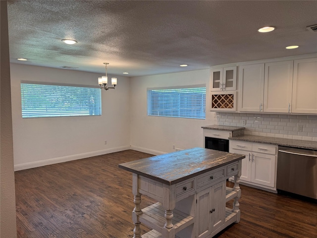 10388 Sandra Lynn Dr, Dallas, TX 75228 - kitchen with stainless steel dishwasher, white cabinetry, tasteful backsplash, baseboards, and dark wood finished floors