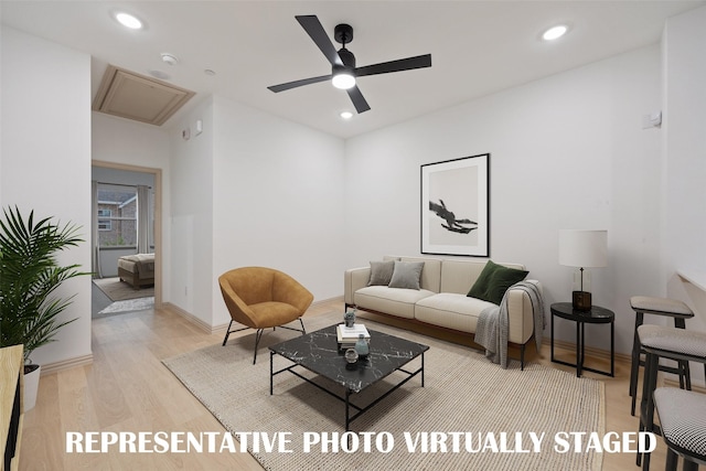 living area featuring ceiling fan, light wood-type flooring, recessed lighting, attic access, and baseboards