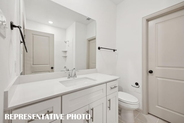 bathroom featuring vanity, tile patterned flooring, recessed lighting, toilet, and a shower