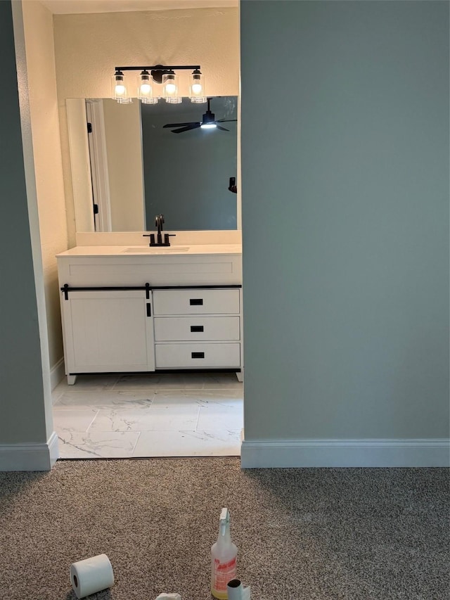 bathroom with vanity and baseboards