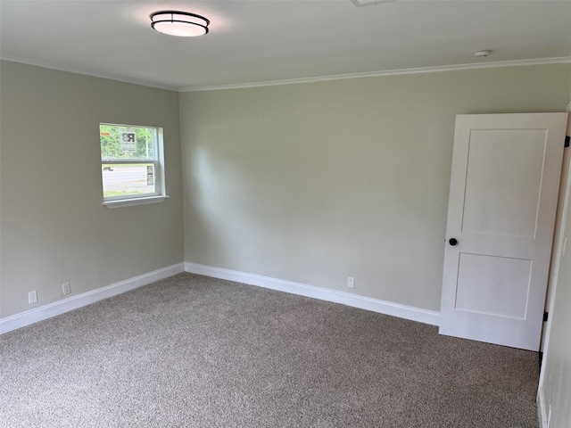 empty room featuring carpet flooring, baseboards, and ornamental molding