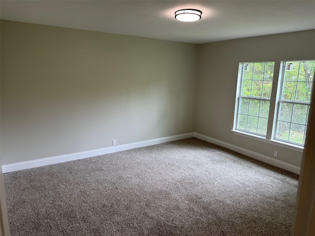empty room with carpet floors and baseboards