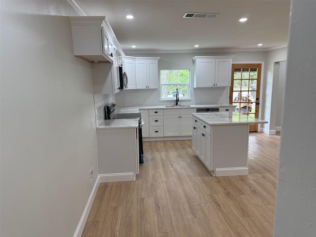 kitchen featuring recessed lighting, visible vents, a sink, baseboards, and black electric range oven