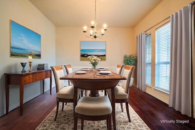 dining space with a chandelier, dark wood-type flooring, and healthy amount of natural light