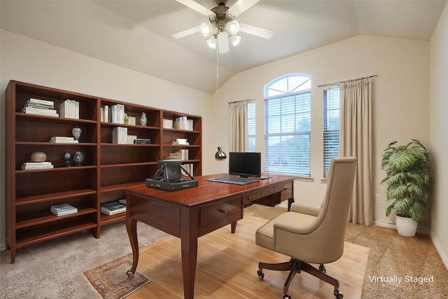 office area with a ceiling fan, lofted ceiling, and baseboards