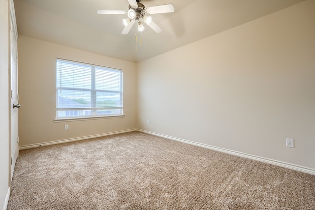 empty room with carpet floors, a ceiling fan, baseboards, and lofted ceiling