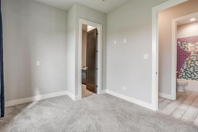 521 Echo Glade Ct, Azle, TX 76020 - unfurnished bedroom featuring connected bathroom, baseboards, and carpet flooring