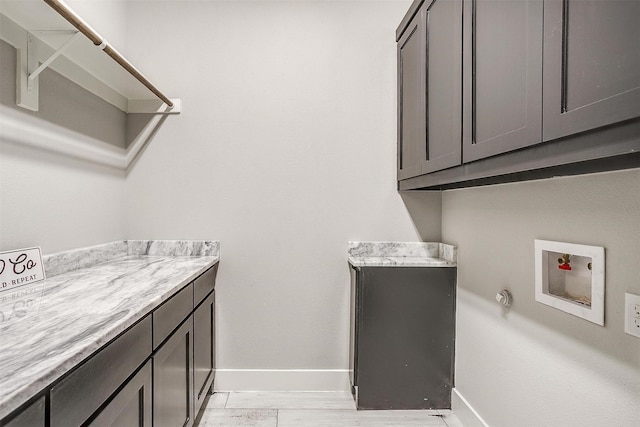 521 Echo Glade Ct, Azle, TX 76020 - washroom featuring cabinet space, baseboards, hookup for a washing machine, and light wood finished floors