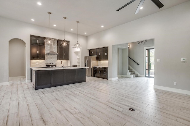 521 Echo Glade Ct, Azle, TX 76020 - kitchen with appliances with stainless steel finishes, a sink, wall chimney range hood, light countertops, and dark brown cabinets
