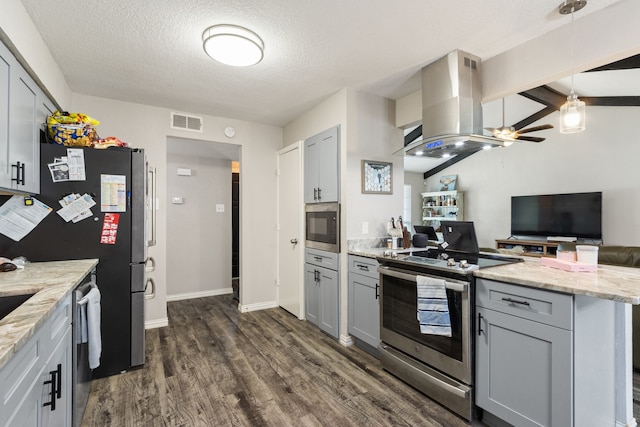 201 Volunteer Dr, Arlington, TX 76014 - kitchen with dark wood-style flooring, island exhaust hood, gray cabinets, visible vents, and appliances with stainless steel finishes