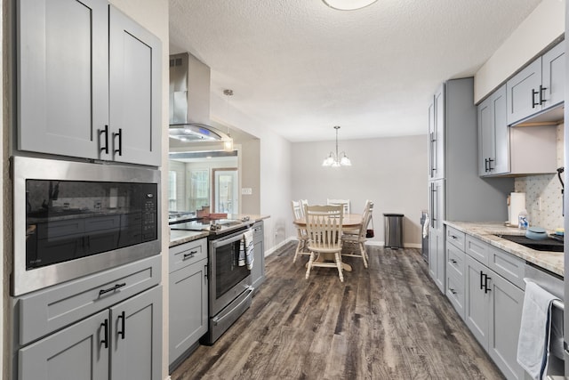 201 Volunteer Dr, Arlington, TX 76014 - kitchen featuring tasteful backsplash, a textured ceiling, dark wood finished floors, island range hood, and appliances with stainless steel finishes