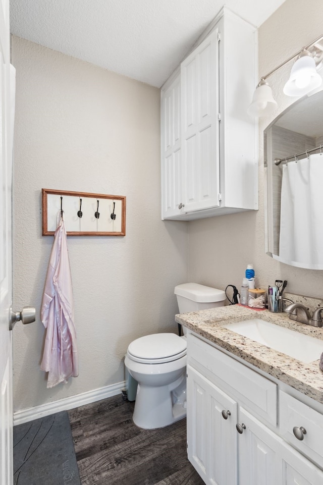 201 Volunteer Dr, Arlington, TX 76014 - full bathroom with vanity, baseboards, a textured ceiling, toilet, and wood finished floors