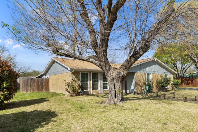 201 Volunteer Dr, Arlington, TX 76014 - rear view of house featuring a shingled roof, a lawn, fence, and brick siding