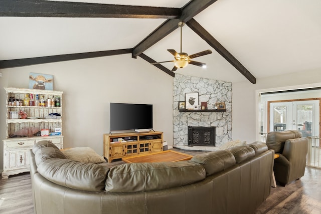 201 Volunteer Dr, Arlington, TX 76014 - living room with a stone fireplace, ceiling fan, vaulted ceiling with beams, and wood finished floors