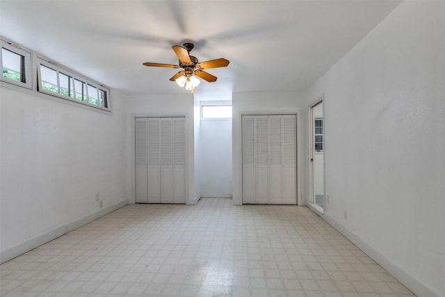 7219 Hickey Rd, Azle, TX 76020 - unfurnished bedroom with light flooring, multiple closets, baseboards, and a ceiling fan