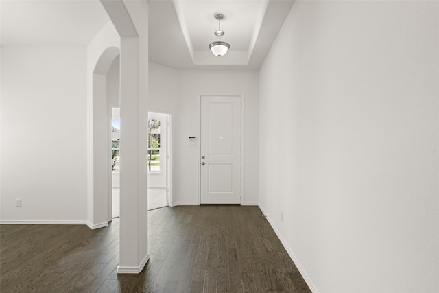 7745 Gatevine Ave, Joshua, TX 76058 - entryway featuring arched walkways, dark wood-style flooring, baseboards, and a tray ceiling
