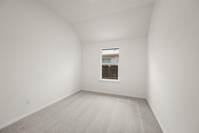7745 Gatevine Ave, Joshua, TX 76058 - empty room featuring vaulted ceiling, carpet flooring, and baseboards