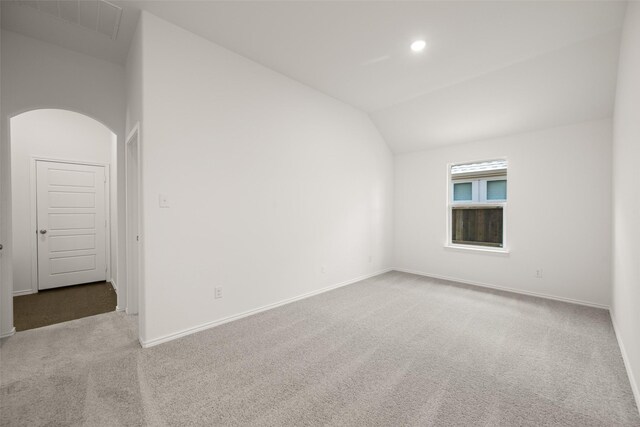 7745 Gatevine Ave, Joshua, TX 76058 - carpeted empty room featuring baseboards, lofted ceiling, arched walkways, and recessed lighting