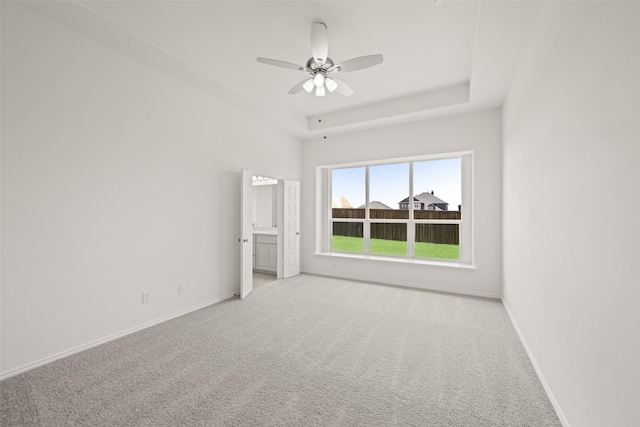 7745 Gatevine Ave, Joshua, TX 76058 - empty room with ceiling fan, light colored carpet, baseboards, and a tray ceiling