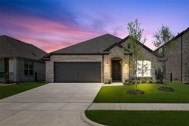 7745 Gatevine Ave, Joshua, TX 76058 - french country style house featuring driveway, a garage, a lawn, brick siding, and a shingled roof