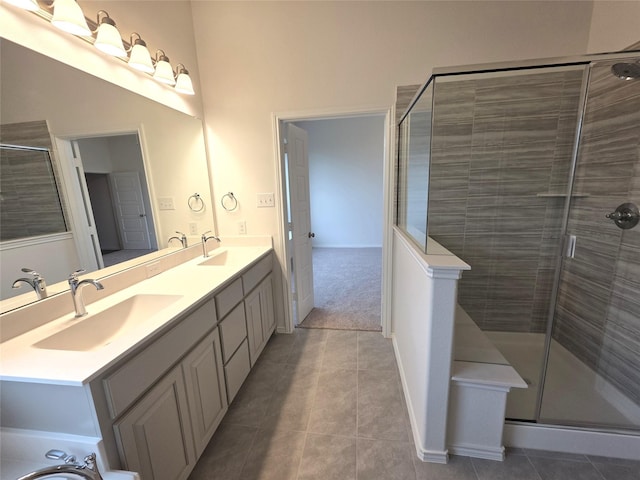 full bathroom featuring a shower stall, a sink, and tile patterned flooring