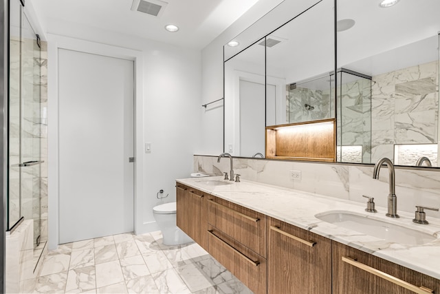 bathroom with toilet, marble finish floor, a sink, and visible vents