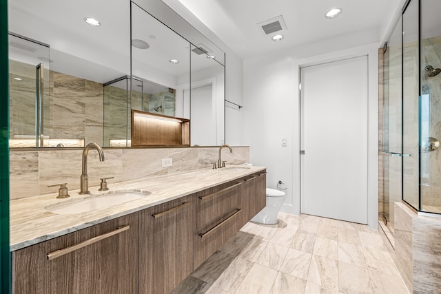 full bath featuring a shower stall, a sink, visible vents, and toilet