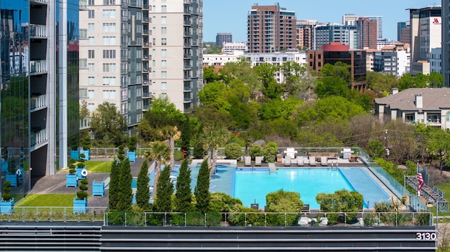 view of pool with a city view