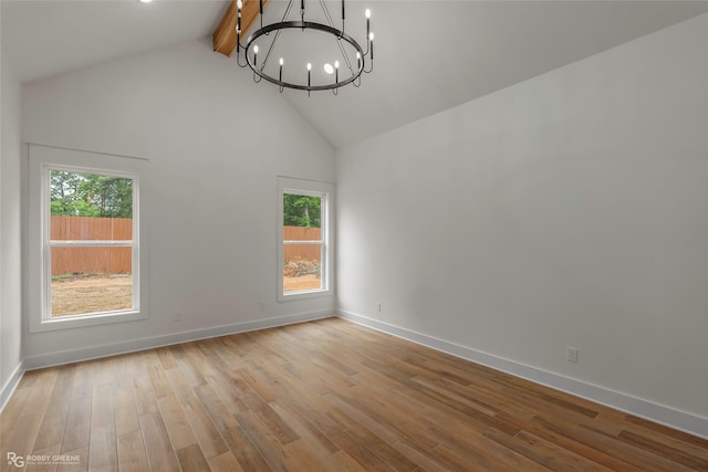 386 Newburn Ln, Shreveport, LA 71106 - empty room featuring a healthy amount of sunlight, beam ceiling, a chandelier, and high vaulted ceiling