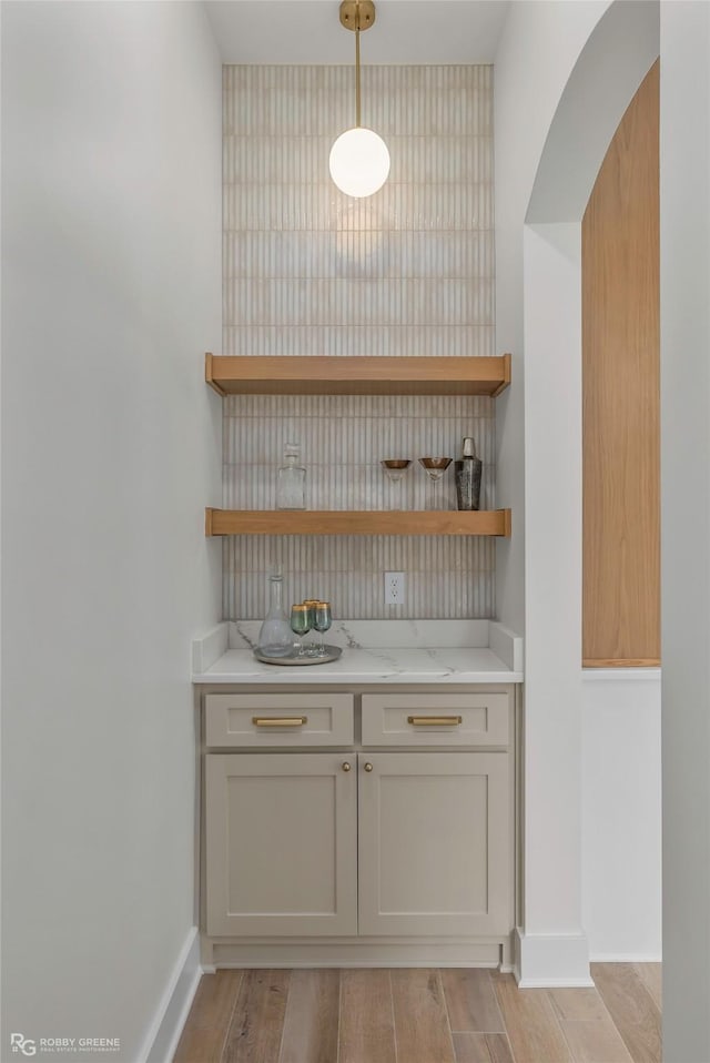 386 Newburn Ln, Shreveport, LA 71106 - bar with baseboards, light wood finished floors, and decorative light fixtures