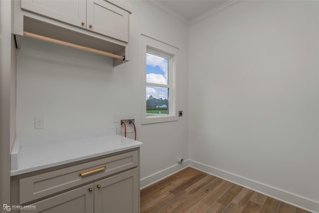 386 Newburn Ln, Shreveport, LA 71106 - laundry area featuring baseboards, ornamental molding, hookup for a washing machine, dark wood-type flooring, and cabinet space