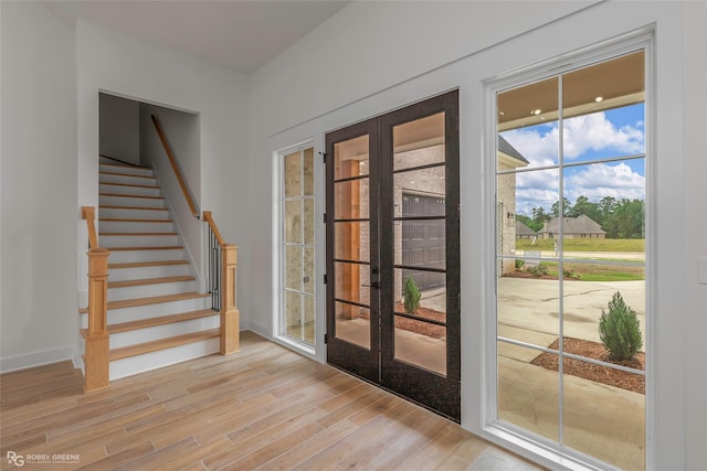 386 Newburn Ln, Shreveport, LA 71106 - entryway featuring baseboards, stairway, french doors, and light wood-style flooring