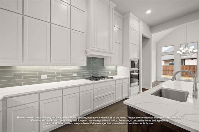 2613 Lee St, Burleson, TX 76028 - kitchen with stainless steel appliances, white cabinets, backsplash, hanging light fixtures, and a chandelier