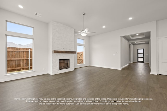 2613 Lee St, Burleson, TX 76028 - unfurnished living room featuring plenty of natural light, a fireplace, dark wood-type flooring, recessed lighting, and a ceiling fan