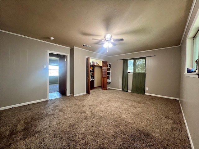 unfurnished bedroom featuring crown molding, visible vents, baseboards, and light colored carpet