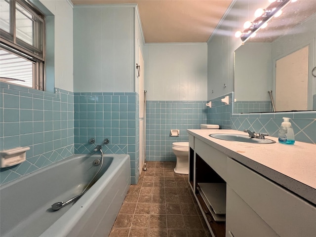 bathroom featuring vanity, toilet, a bath, wainscoting, and tile walls